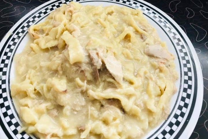 A plate of Carl's Townhouse homemade chicken and noodles on the diner counter