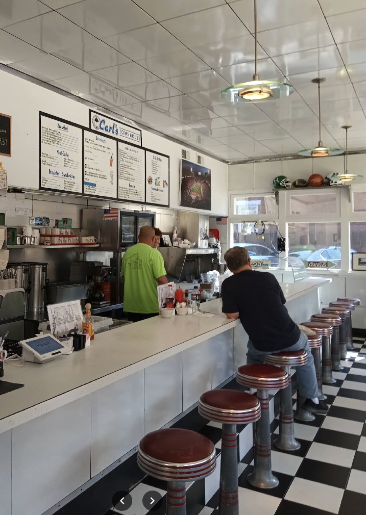 Inside Carl's Townhouse: the checkerboard floor and red vinyl counter stools